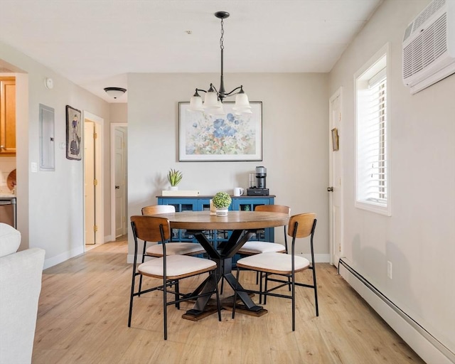 157 Franklin St Unit D3, Stoneham, MA 02180 - dining room featuring a baseboard heating unit, a wall mounted air conditioner, light wood finished floors, a chandelier, and electric panel