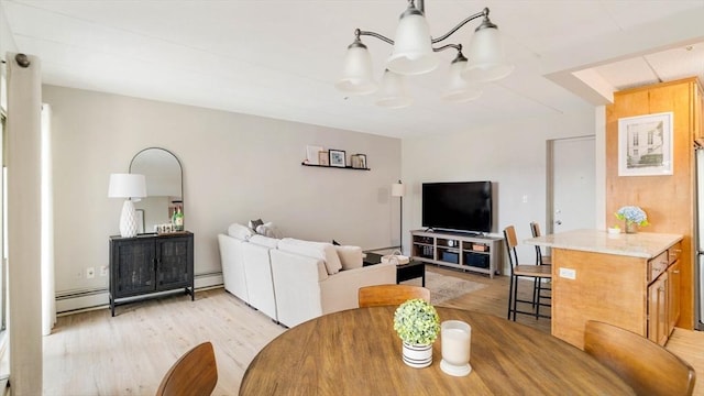 157 Franklin St Unit D3, Stoneham, MA 02180 - dining space with light wood-style floors, a baseboard radiator, baseboard heating, and a chandelier