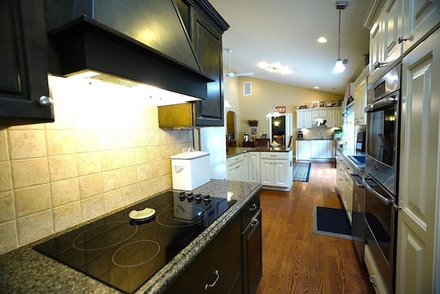 895 Dennison Dr, Southbridge, MA 01550 - kitchen with black electric stovetop, custom range hood, lofted ceiling, dark wood-style flooring, and oven