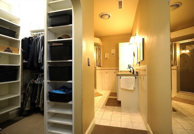 895 Dennison Dr, Southbridge, MA 01550 - bathroom featuring tile patterned floors, a stall shower, a walk in closet, and vanity