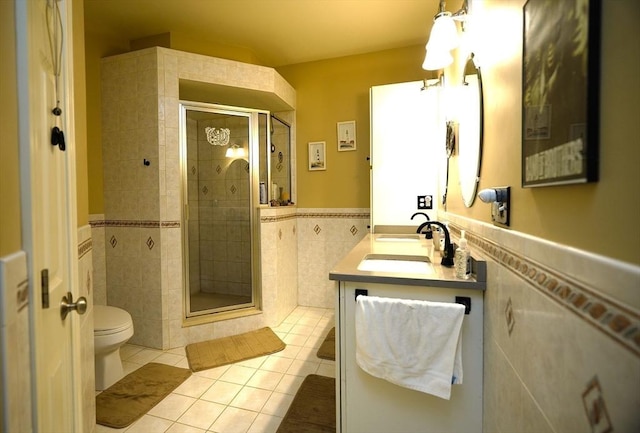 895 Dennison Dr, Southbridge, MA 01550 - full bath featuring tile patterned floors, tile walls, a shower stall, double vanity, and wainscoting