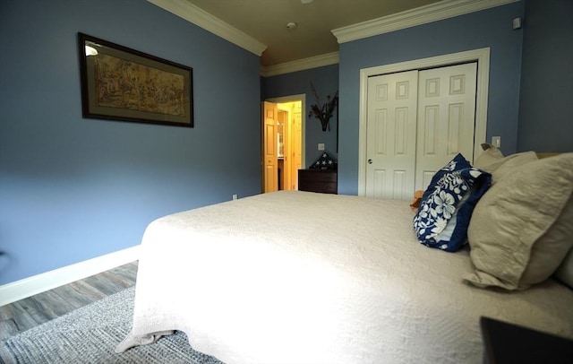 895 Dennison Dr, Southbridge, MA 01550 - bedroom with ornamental molding, a closet, and wood finished floors