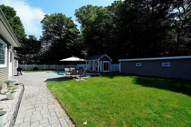 895 Dennison Dr, Southbridge, MA 01550 - fenced backyard featuring a patio area and a storage shed