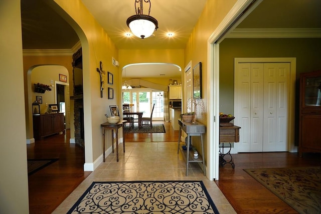 895 Dennison Dr, Southbridge, MA 01550 - foyer with arched walkways, tile patterned flooring, crown molding, and a fireplace