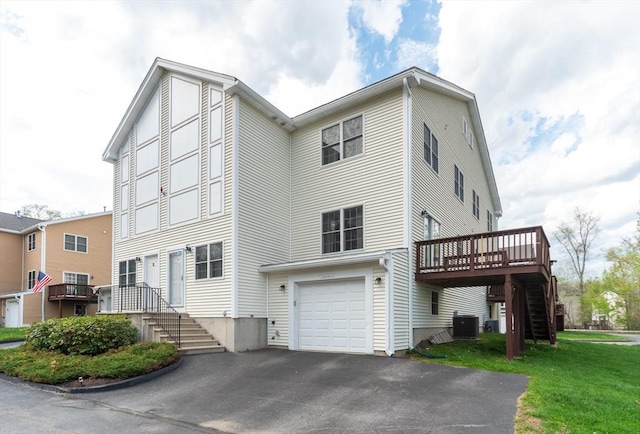 1 Knotts St Unit 1, Hudson, MA 01749 - view of front facade featuring cooling unit, stairs, a deck, asphalt driveway, and a front yard