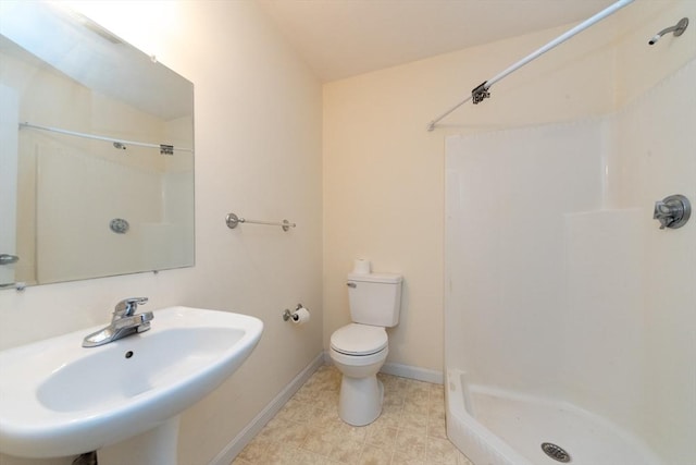 1 Knotts St Unit 1, Hudson, MA 01749 - bathroom featuring a sink, a stall shower, toilet, baseboards, and tile patterned flooring