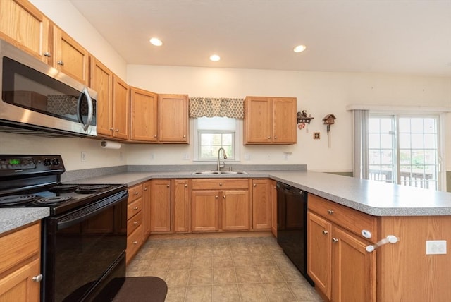 1 Knotts St Unit 1, Hudson, MA 01749 - kitchen with black appliances, a sink, a peninsula, light countertops, and recessed lighting
