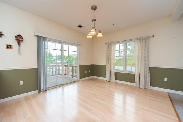 1 Knotts St Unit 1, Hudson, MA 01749 - empty room with wood finished floors, baseboards, and a chandelier