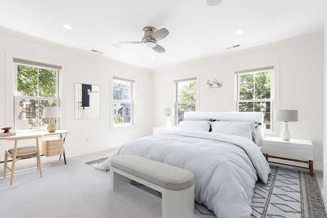 bedroom with carpet floors, crown molding, multiple windows, and ceiling fan