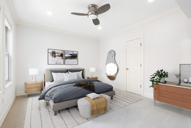 carpeted bedroom with ceiling fan and ornamental molding