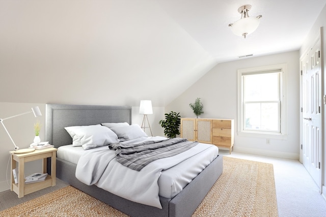 bedroom featuring carpet and vaulted ceiling