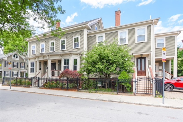 townhome / multi-family property featuring a porch