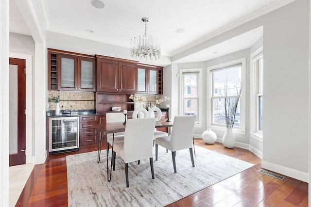 kitchen featuring stainless steel appliances, decorative backsplash, a raised ceiling, and a kitchen island