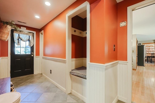 interior space with recessed lighting, visible vents, and wainscoting