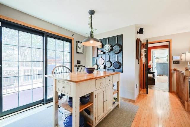 kitchen with open shelves, wood counters, white cabinetry, light wood-style floors, and hanging light fixtures