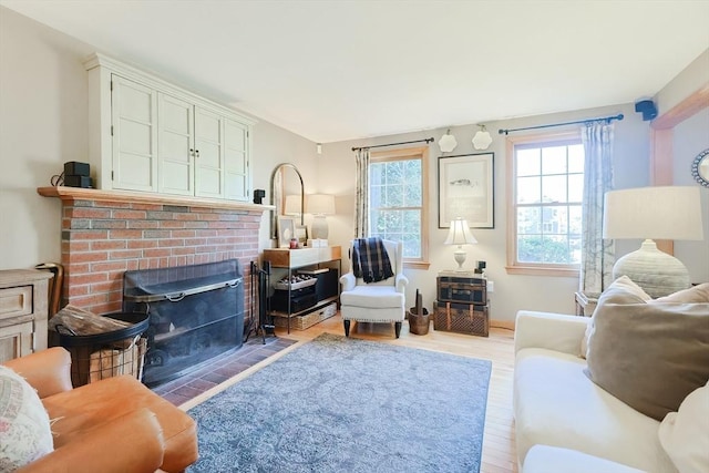 living area featuring a fireplace and light wood finished floors