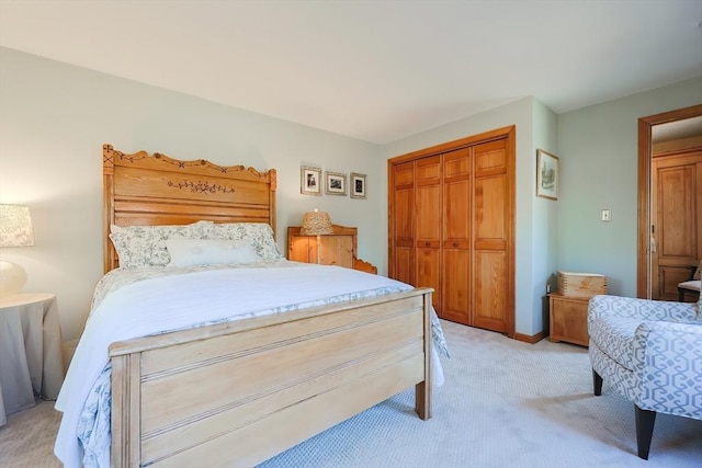 bedroom featuring a closet and light carpet