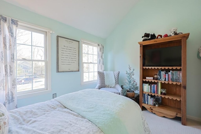 carpeted bedroom featuring lofted ceiling