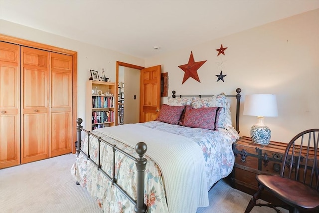 bedroom featuring a closet and light carpet