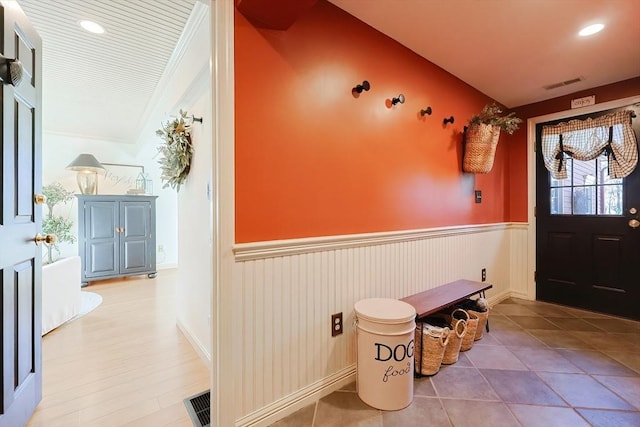 foyer entrance with recessed lighting, visible vents, wainscoting, and crown molding