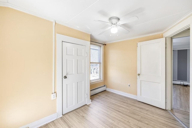 unfurnished bedroom with crown molding, a baseboard radiator, baseboard heating, baseboards, and light wood-type flooring