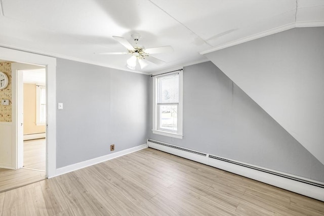 additional living space featuring ceiling fan, baseboard heating, wood finished floors, and baseboards
