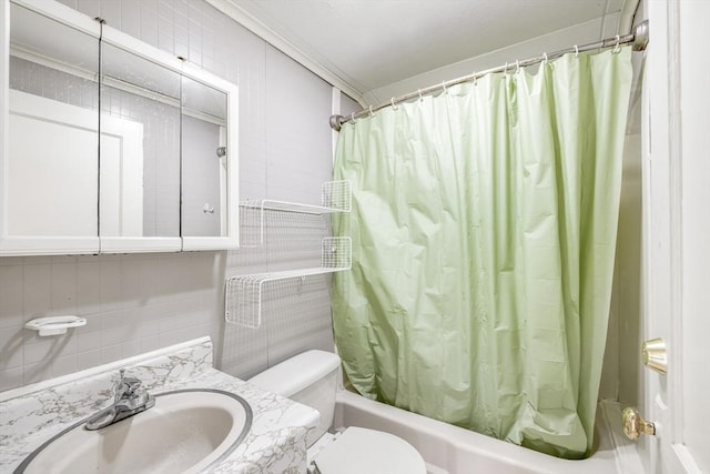 bathroom with tasteful backsplash, toilet, tile walls, shower / bathtub combination with curtain, and vanity