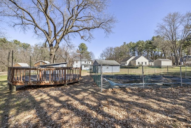 view of yard featuring a residential view, a wooden deck, and fence