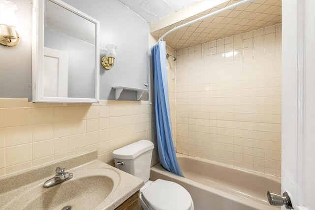 bathroom with tile walls, shower / tub combo with curtain, toilet, and vanity