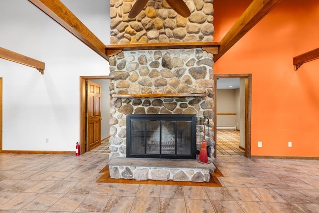 details featuring ceiling fan, a fireplace, and baseboard heating