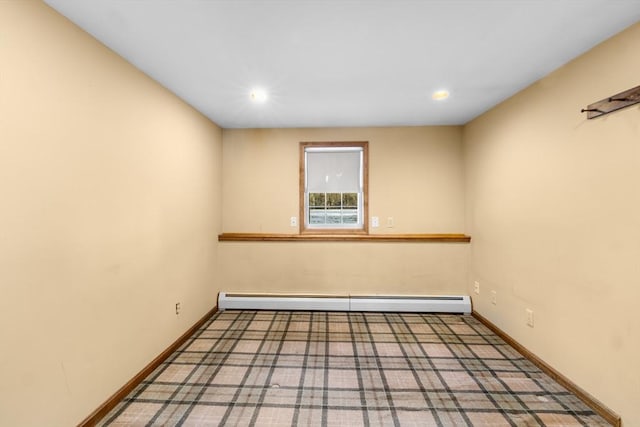 carpeted empty room with baseboard heating