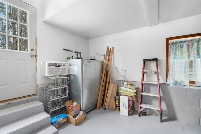 miscellaneous room featuring a wall mounted AC and concrete floors