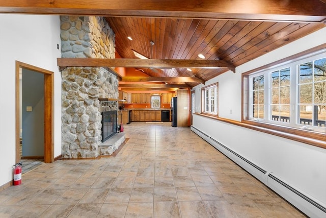 unfurnished living room featuring a baseboard radiator, plenty of natural light, a fireplace, and wooden ceiling