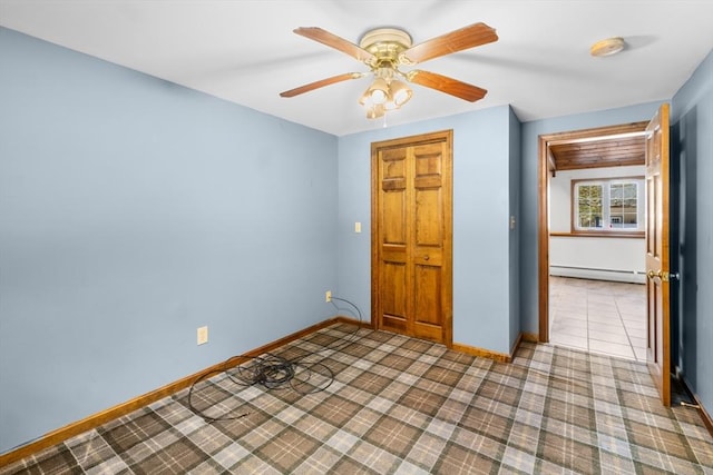 unfurnished bedroom featuring ceiling fan and baseboard heating