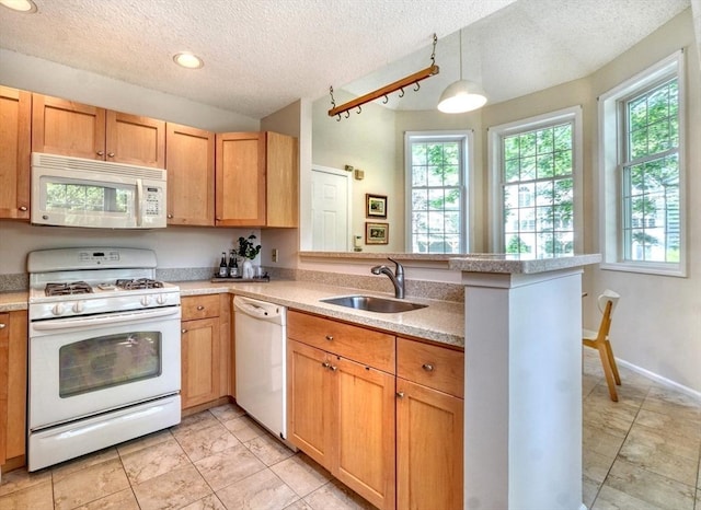 9 Knollwood Ct Unit 9, Burlington, MA 01803 - kitchen featuring white appliances, a sink, a peninsula, light countertops, and a textured ceiling