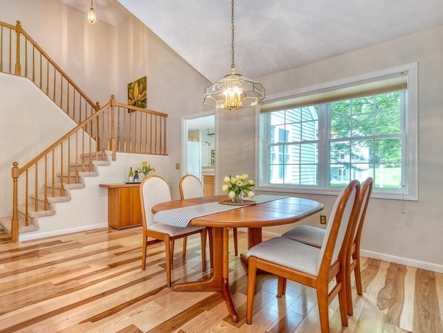 9 Knollwood Ct Unit 9, Burlington, MA 01803 - dining room with stairway, light wood-style floors, a chandelier, baseboards, and high vaulted ceiling