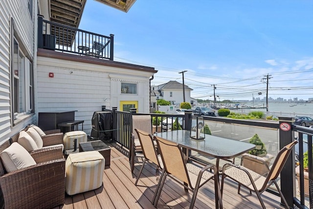 deck featuring grilling area and a water view