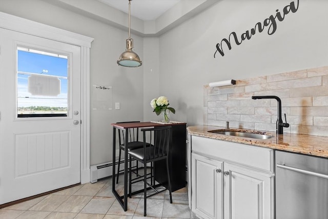 bar with light tile patterned flooring, a sink, baseboard heating, decorative backsplash, and pendant lighting