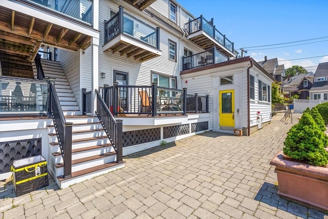 back of property featuring a patio and stairway