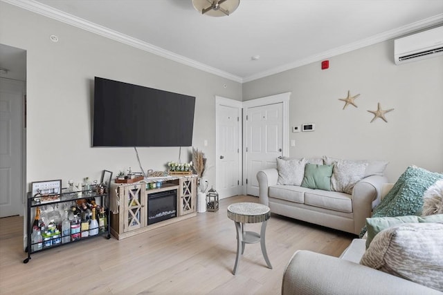 living area with light wood finished floors, a glass covered fireplace, crown molding, and a wall mounted AC