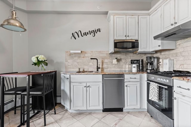 kitchen featuring stainless steel appliances, light stone counters, a sink, and under cabinet range hood