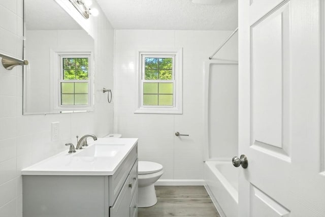 248 Pheland St, Springfield, MA 01109 - bathroom featuring vanity, plenty of natural light, toilet, wood finished floors, and a textured ceiling