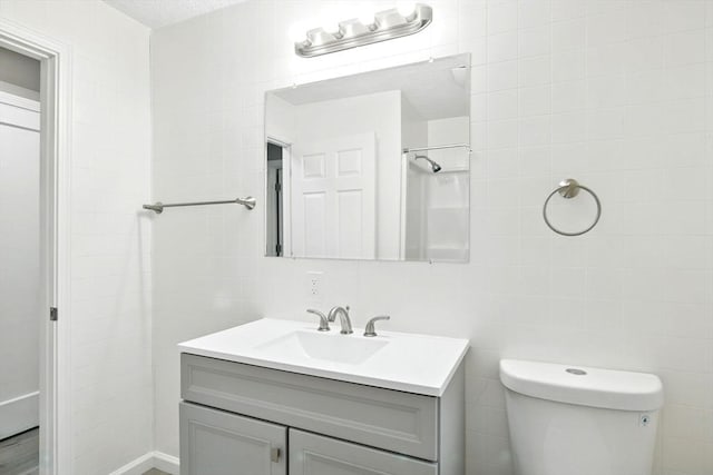 248 Pheland St, Springfield, MA 01109 - bathroom with vanity, toilet, and tile walls