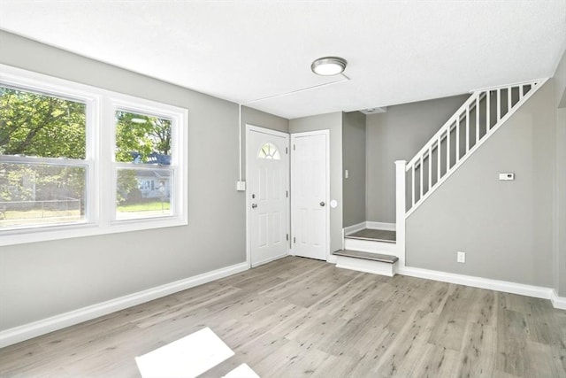 248 Pheland St, Springfield, MA 01109 - foyer entrance featuring wood finished floors, stairway, and baseboards