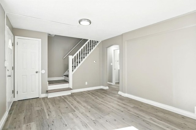 248 Pheland St, Springfield, MA 01109 - entrance foyer featuring light wood-style floors, baseboards, stairs, and arched walkways
