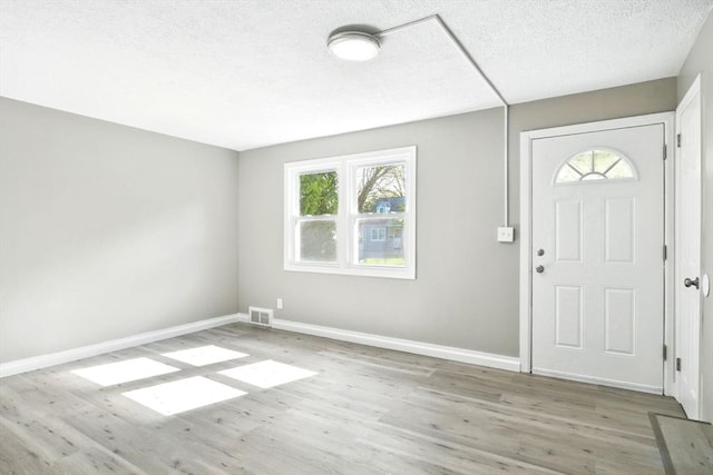 248 Pheland St, Springfield, MA 01109 - foyer featuring wood finished floors, a textured ceiling, and baseboards