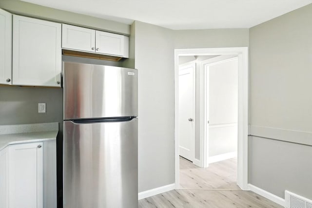 248 Pheland St, Springfield, MA 01109 - kitchen featuring freestanding refrigerator, light wood-style flooring, white cabinetry, light countertops, and baseboards