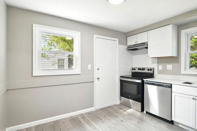 248 Pheland St, Springfield, MA 01109 - kitchen featuring stainless steel appliances, under cabinet range hood, light wood-type flooring, and white cabinets