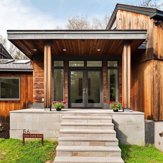 entrance to property featuring french doors and covered porch