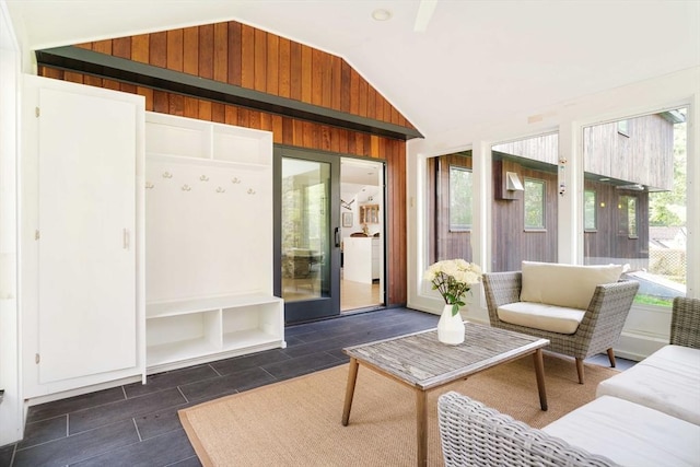 sunroom featuring vaulted ceiling